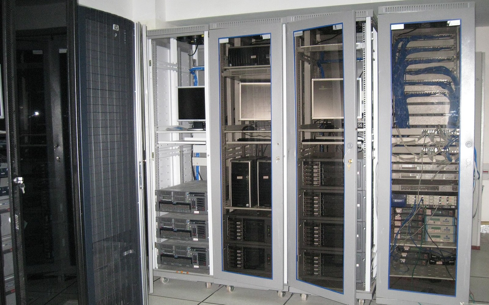 A rack of mixed hardware with labelled shelves in a machine room